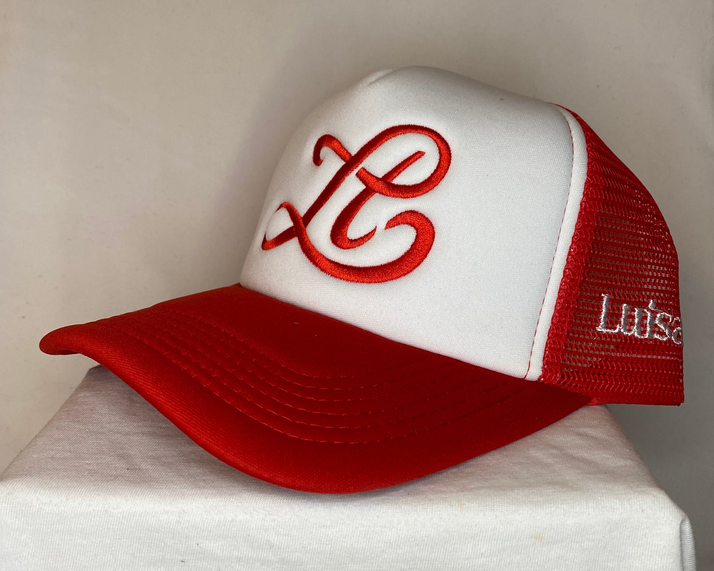 Red and white golf club head cover with a logo on a light background