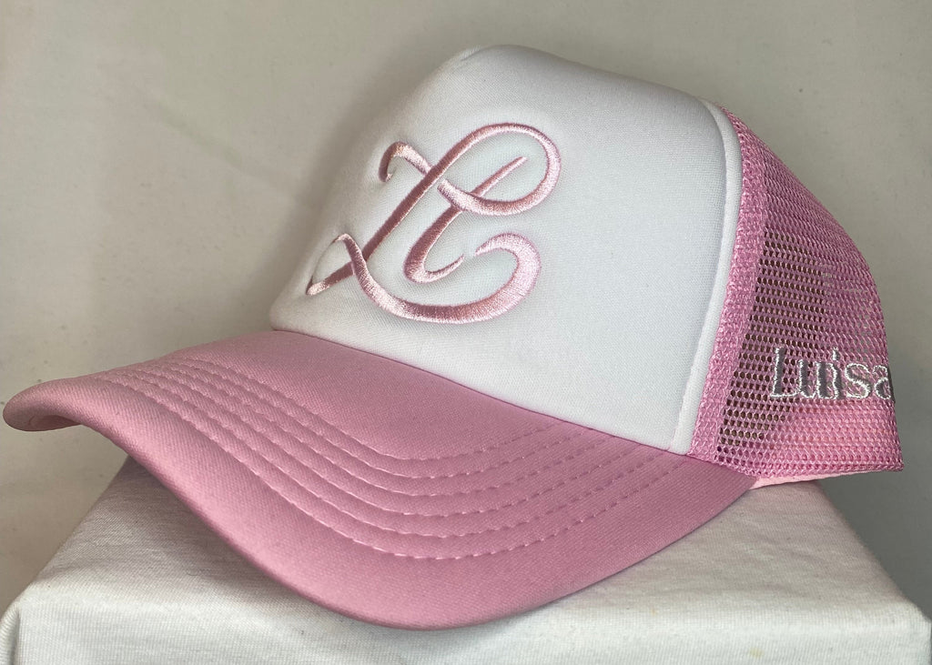 Pink and white cap with a logo on a light background