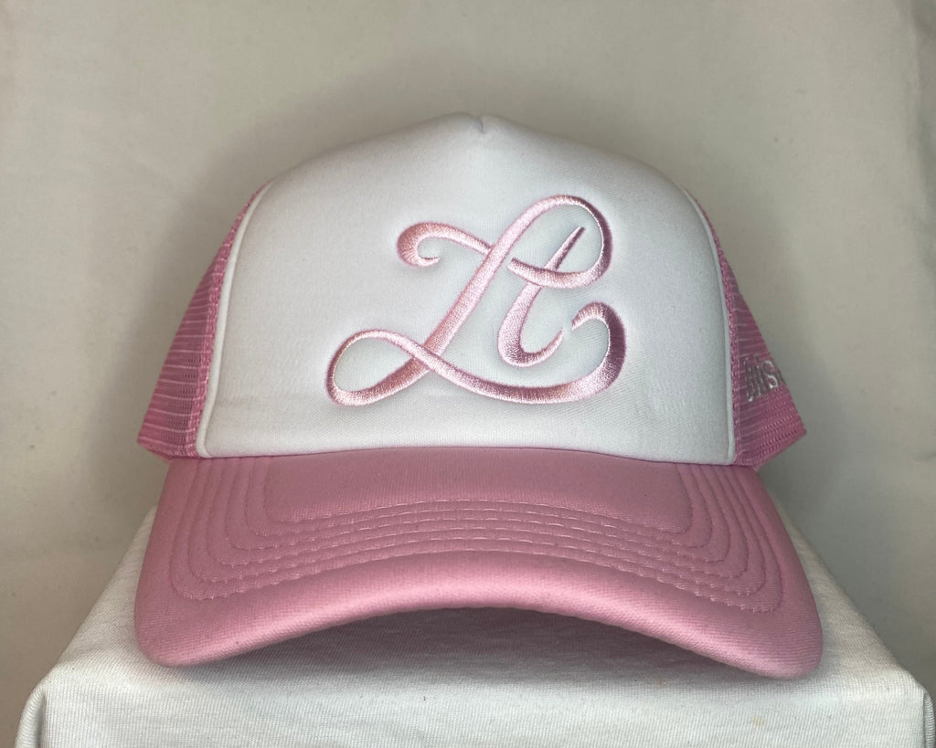 Pink and white golf club head cover on a white background