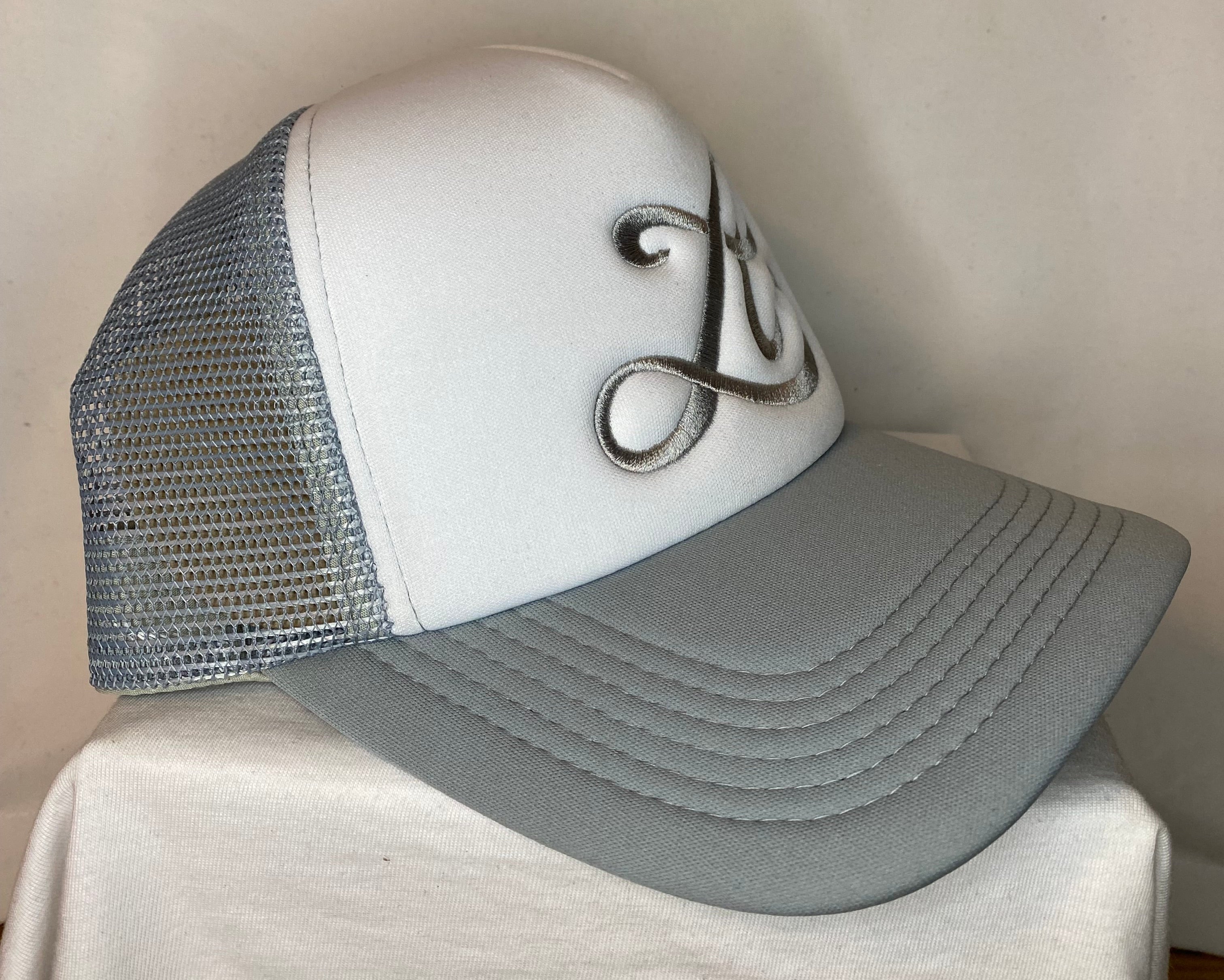 Gray and white shoe with a brand logo on a light background